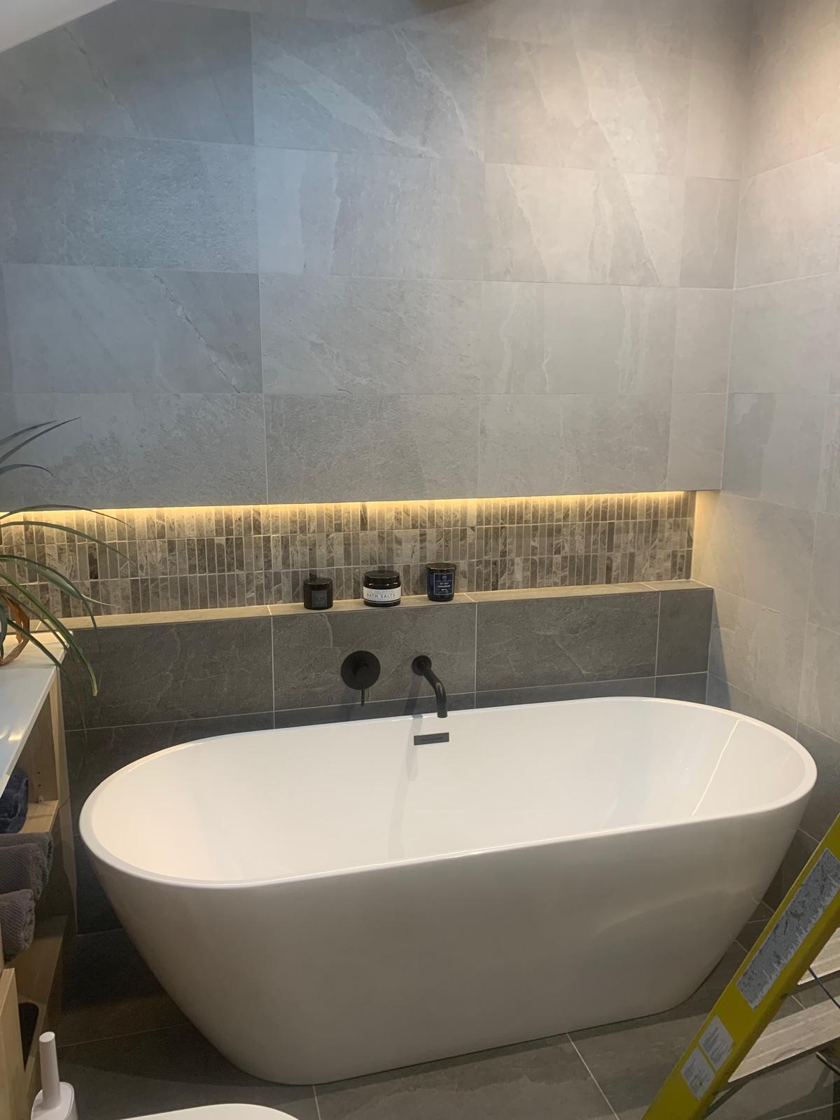 Bathroom LED niche lighting and zone-compliant electrical finish
